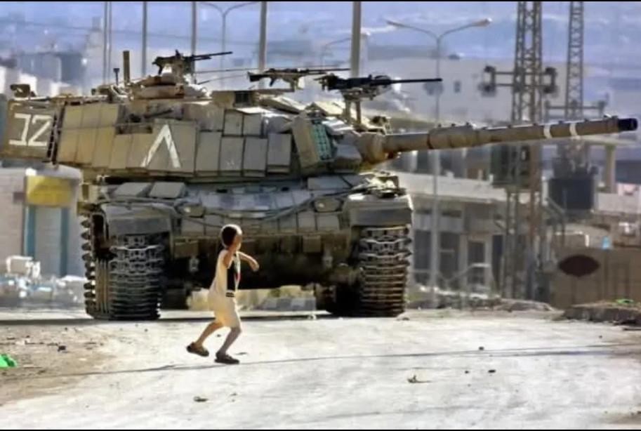 old image of 11 years old Palestinian child throwing a rock at an Israeli tank. 

IDF chased him and shot him to death a few days after the picture was taken